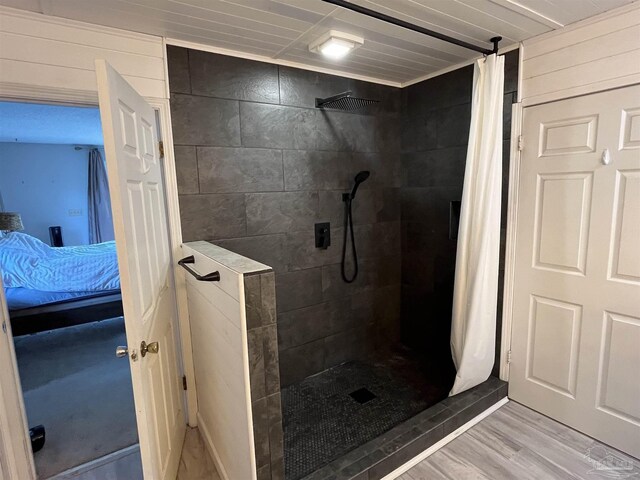 bathroom with wood-type flooring and walk in shower