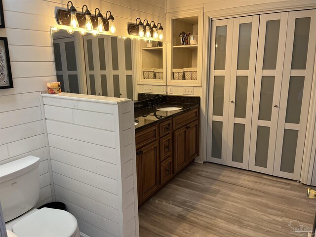 bathroom with vanity, wood-type flooring, and toilet