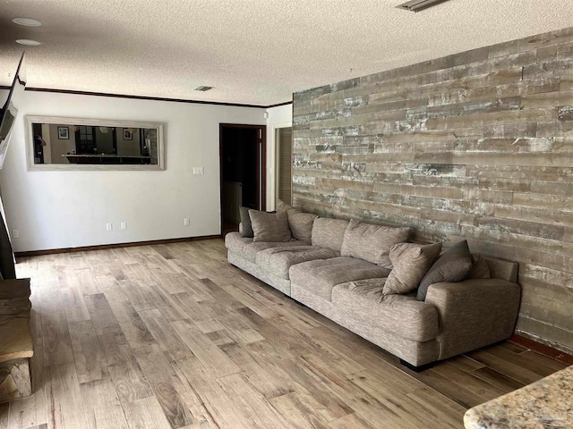 unfurnished living room featuring a textured ceiling and hardwood / wood-style floors