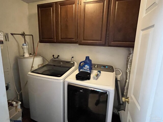 clothes washing area featuring cabinets, independent washer and dryer, and gas water heater