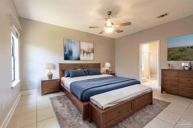 bedroom featuring ceiling fan, ensuite bathroom, and light tile patterned floors