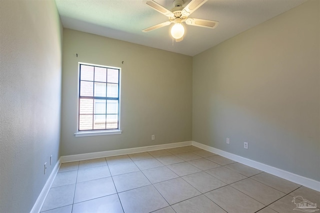 spare room with ceiling fan and light tile patterned floors