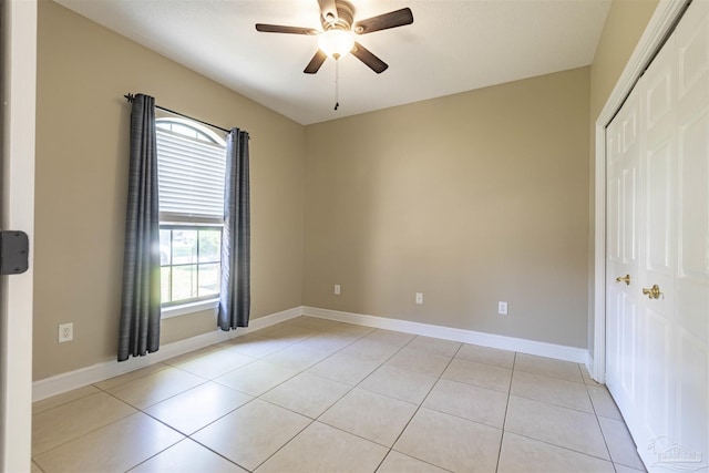 unfurnished bedroom with a closet, ceiling fan, and light tile patterned flooring