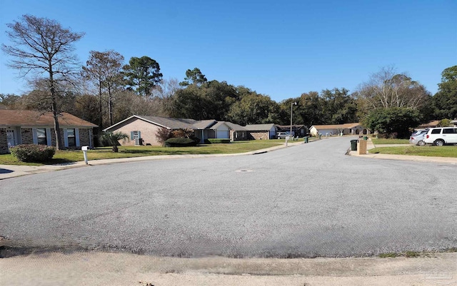 8176 Camelford Dr, Pensacola, FL 32506 - view of street featuring a residential view, curbs, street lights, and sidewalks