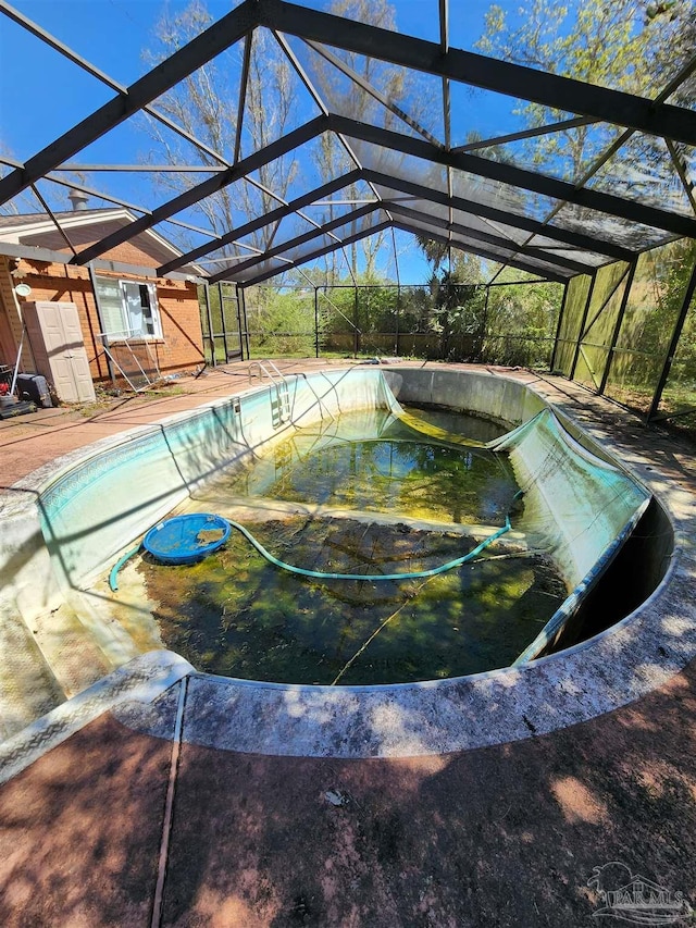8176 Camelford Dr, Pensacola, FL 32506 - view of swimming pool featuring glass enclosure, a patio, and an empty pool