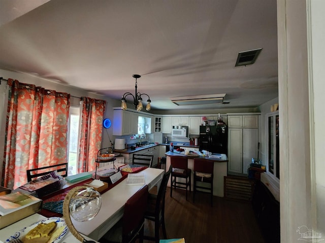 8176 Camelford Dr, Pensacola, FL 32506 - dining space with visible vents and dark wood-style flooring