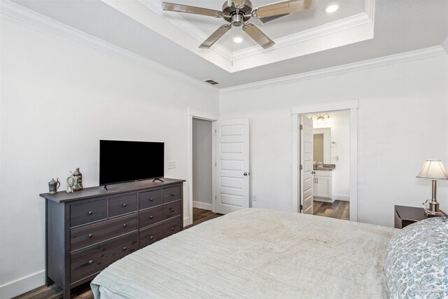 bedroom featuring ceiling fan, ensuite bath, and dark hardwood / wood-style floors