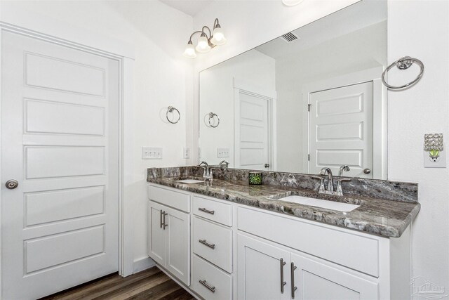 bathroom featuring vanity and hardwood / wood-style flooring