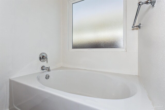 bathroom with a tub to relax in