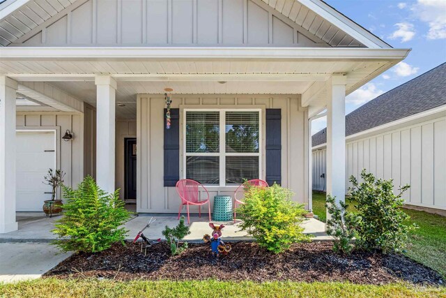 view of front of house with a garage, covered porch, and a front yard