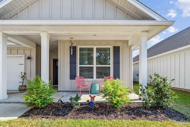 entrance to property with covered porch and board and batten siding