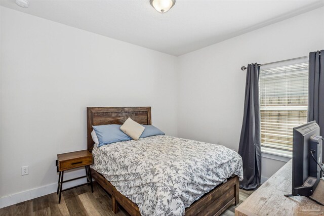 bedroom featuring dark wood-type flooring