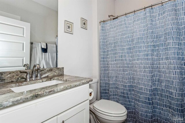 bathroom with vanity, toilet, and a shower with curtain