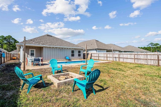 view of yard with a patio, an outdoor fire pit, a fenced backyard, and a fenced in pool