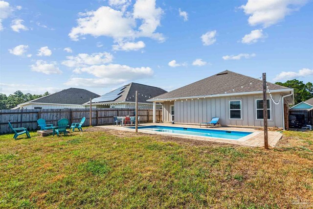 view of swimming pool with a lawn and a patio