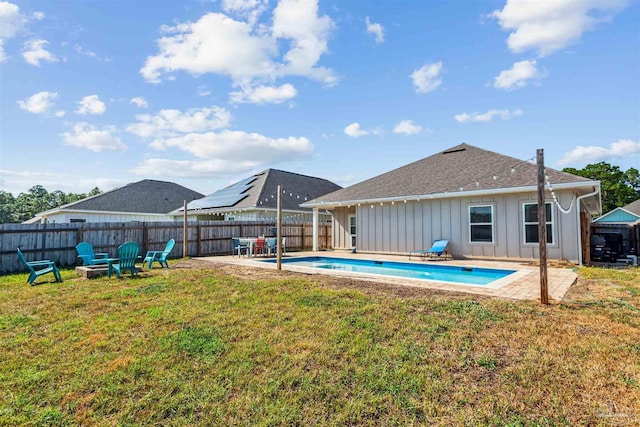 view of swimming pool with a yard, a patio area, a fenced backyard, and a fenced in pool