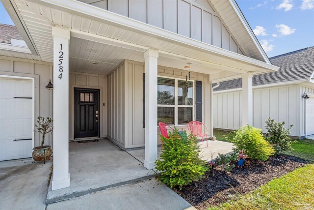 view of exterior entry with a porch