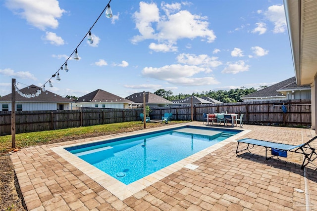 view of swimming pool featuring a patio area, a fenced backyard, and outdoor dining area