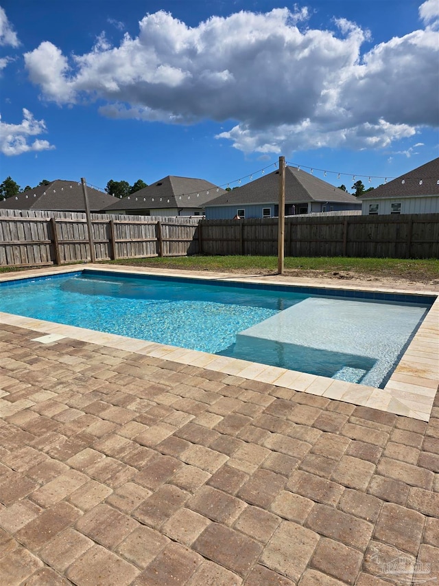 view of swimming pool featuring a fenced backyard and a fenced in pool