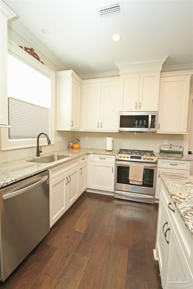 kitchen with white cabinets, dark hardwood / wood-style floors, sink, and stainless steel appliances