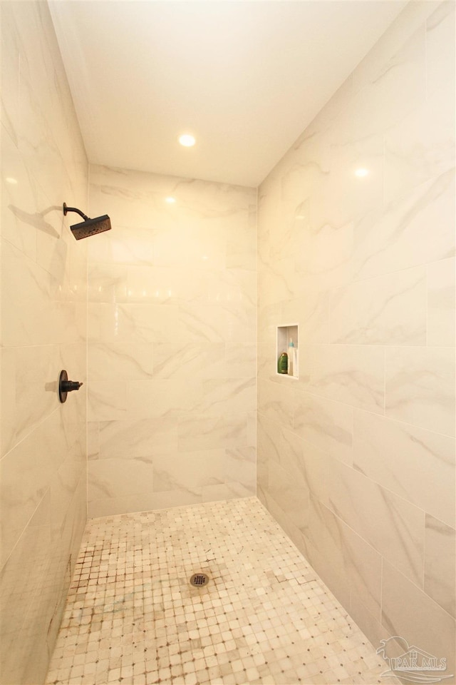 bathroom with tiled shower