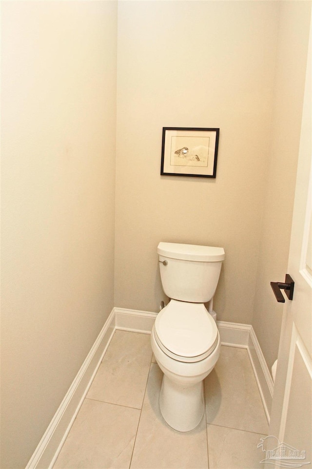 bathroom with tile patterned flooring and toilet