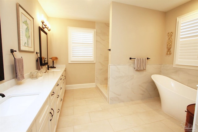 bathroom featuring tile patterned floors, vanity, shower with separate bathtub, and tile walls