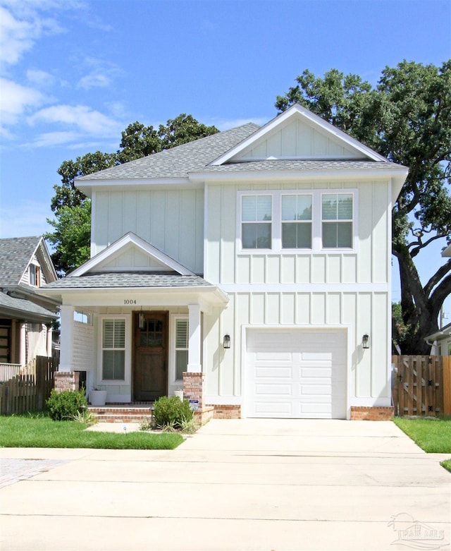 view of front of property with a porch and a garage