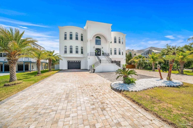 502 Deer Point Dr, Gulf Breeze, FL 32561 - view of front of home with an attached garage, decorative driveway, stucco siding, stairs, and a front lawn