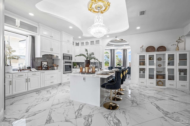 502 Deer Point Dr, Gulf Breeze, FL 32561 - kitchen featuring stainless steel appliances, recessed lighting, a chandelier, white cabinetry, and light marble finish floors