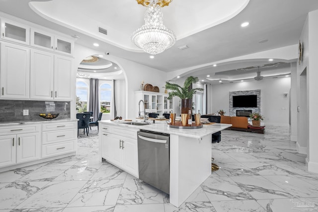 502 Deer Point Dr, Gulf Breeze, FL 32561 - kitchen with dishwasher, a tray ceiling, a sink, arched walkways, and recessed lighting