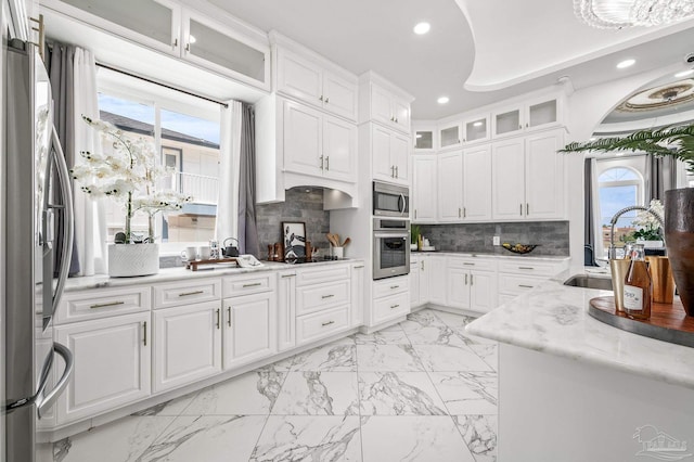502 Deer Point Dr, Gulf Breeze, FL 32561 - kitchen featuring appliances with stainless steel finishes, a sink, light marble finish floors, recessed lighting, and white cabinetry