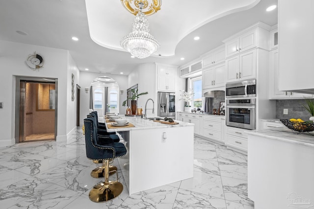502 Deer Point Dr, Gulf Breeze, FL 32561 - kitchen featuring stainless steel appliances, recessed lighting, a chandelier, decorative backsplash, and white cabinets