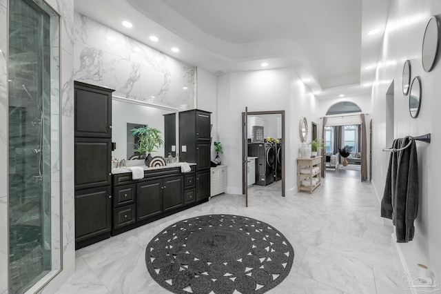 502 Deer Point Dr, Gulf Breeze, FL 32561 - bathroom with marble tiled flooring, recessed lighting, separate washer and dryer, a high ceiling, and a stall shower