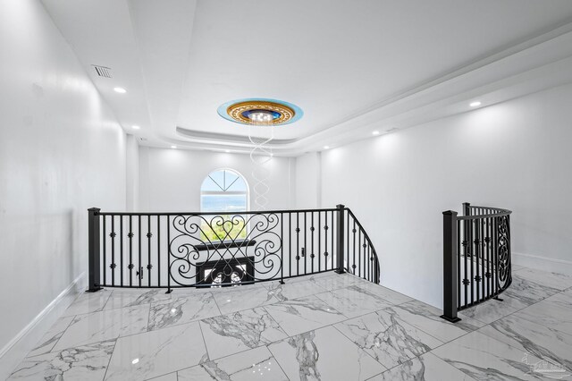 502 Deer Point Dr, Gulf Breeze, FL 32561 - hallway with an upstairs landing, marble look tile flooring, baseboards, recessed lighting, and a raised ceiling