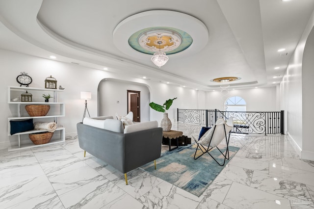 502 Deer Point Dr, Gulf Breeze, FL 32561 - living area featuring a raised ceiling, baseboards, arched walkways, recessed lighting, and marble finish floors
