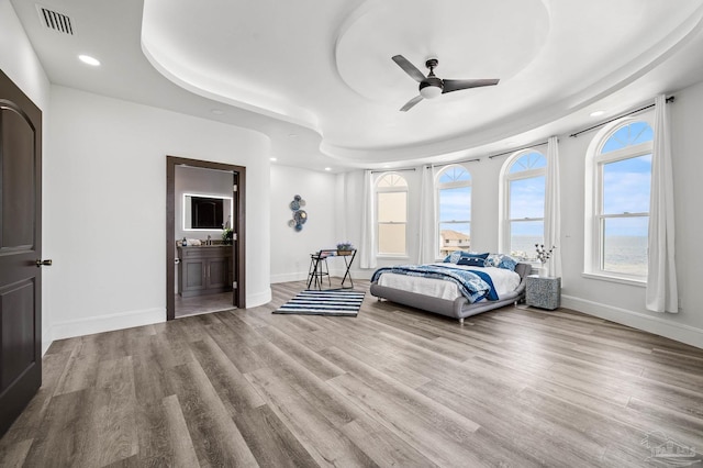 502 Deer Point Dr, Gulf Breeze, FL 32561 - bedroom featuring recessed lighting, baseboards, wood finished floors, ensuite bathroom, and ceiling fan