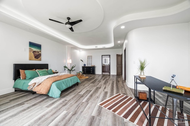 502 Deer Point Dr, Gulf Breeze, FL 32561 - bedroom with wood finished floors, recessed lighting, baseboards, a ceiling fan, and a tray ceiling