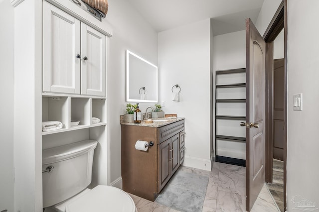 502 Deer Point Dr, Gulf Breeze, FL 32561 - bathroom with marble finish flooring, toilet, baseboards, and vanity