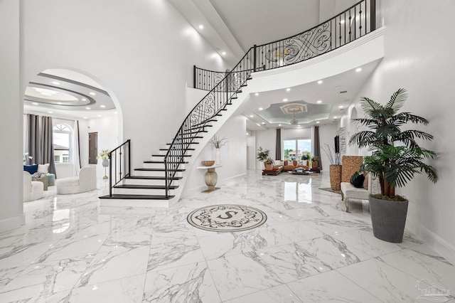 502 Deer Point Dr, Gulf Breeze, FL 32561 - entryway with stairs, marble tiled flooring, healthy amount of natural light, a towering ceiling, and baseboards