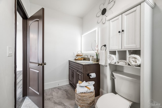 502 Deer Point Dr, Gulf Breeze, FL 32561 - bathroom with marble finish flooring, toilet, vanity, and baseboards