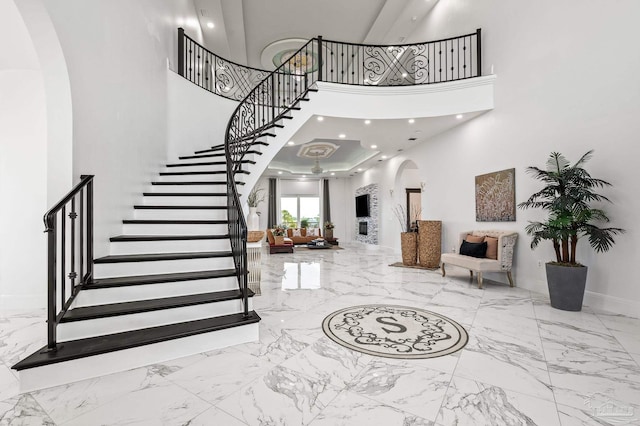 502 Deer Point Dr, Gulf Breeze, FL 32561 - entryway featuring arched walkways, marble tiled flooring, stairs, baseboards, and a towering ceiling