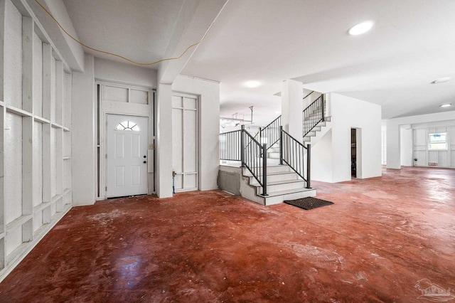 502 Deer Point Dr, Gulf Breeze, FL 32561 - entrance foyer featuring unfinished concrete floors, stairs, and recessed lighting