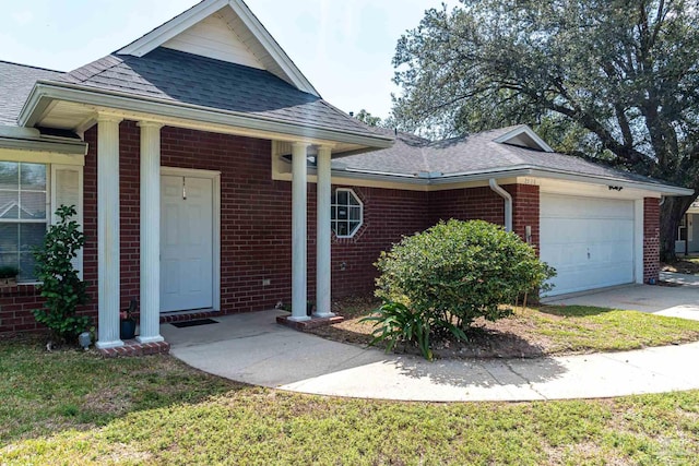 view of front of home with a front lawn and a garage