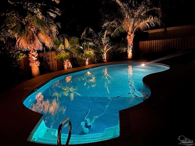 5621 Lobelia Ln, Pensacola, FL 32526 - pool at night featuring a fenced in pool and a fenced backyard