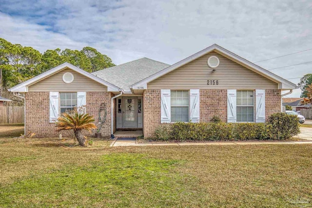 single story home with brick siding, a front lawn, and roof with shingles