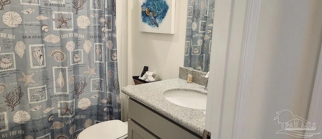 bathroom featuring vanity and toilet