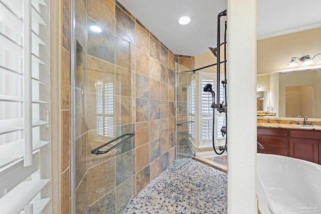 1011 Bucyrus Ln, Cantonment, FL 32533 - bathroom featuring a shower stall, vanity, crown molding, a tub, and recessed lighting