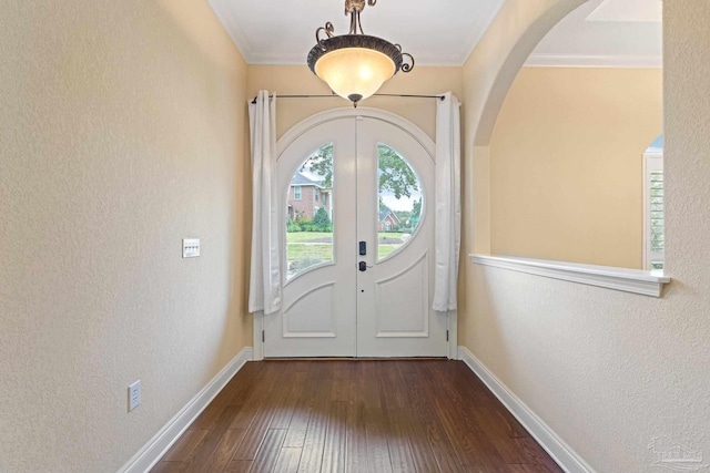 1011 Bucyrus Ln, Cantonment, FL 32533 - foyer entrance featuring arched walkways, hardwood / wood-style flooring, french doors, crown molding, and baseboards