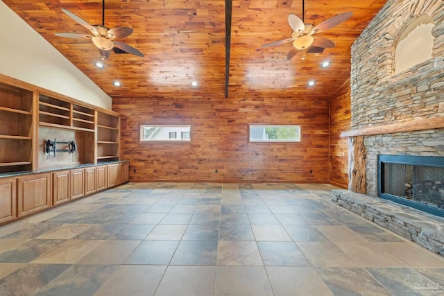 1011 Bucyrus Ln, Cantonment, FL 32533 - unfurnished living room featuring a ceiling fan, wooden ceiling, a stone fireplace, wood walls, and high vaulted ceiling